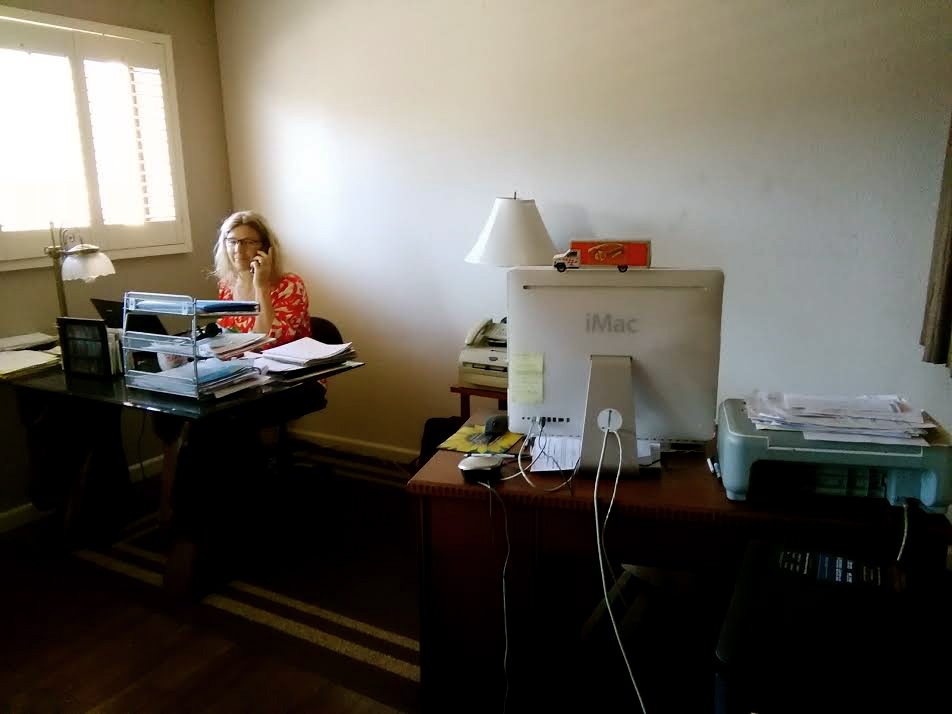 A woman sitting at her desk in front of a computer.